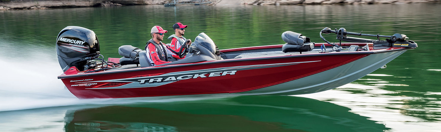 Two people on a red 2019 Tracker Bass Panfish Boats dashing through a lake.